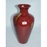 A contemporary red glazed vase with green streaks, 16'' tall.