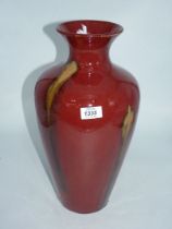 A contemporary red glazed vase with green streaks, 16'' tall.