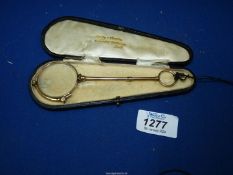 A cased pair of Lorgnette glasses by Curry and Paxton with the original case.