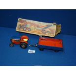 A boxed Gama 77/6 clockwork tractor and tipper trailer, made in Western Germany.