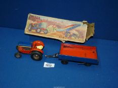 A boxed Gama 77/6 clockwork tractor and tipper trailer, made in Western Germany.