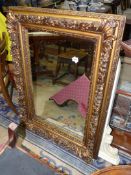 A heavily moulded framed Wall hanging Mirror, 43 1/4'' x 31 1/2'' approx.
