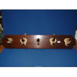 A Bull horn coat rack (horns mounted on a wooden base), reg. no. 82527, 40 1/2" x 7 1/2".