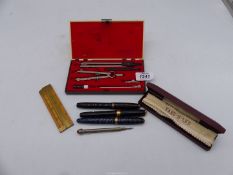 An Intertech drawing set, adjustable ruler, souvenir propelling pencil,