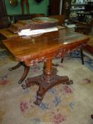 A Walnut and other woods flap-over swivel top Card Table standing on a turned and shaped six sided