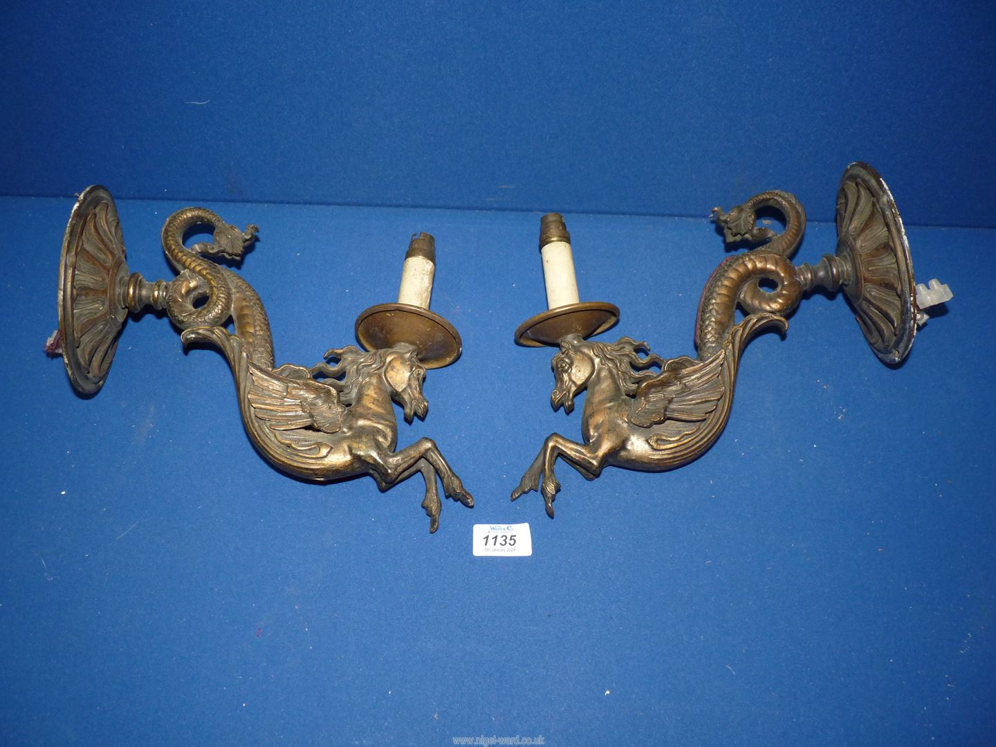 A pair of bronze wall Lights in the form of mythical horses, approx.