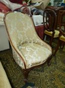 A circa 1900 Mahogany show framed tub shaped Fireside Chair having elegant scroll front legs and