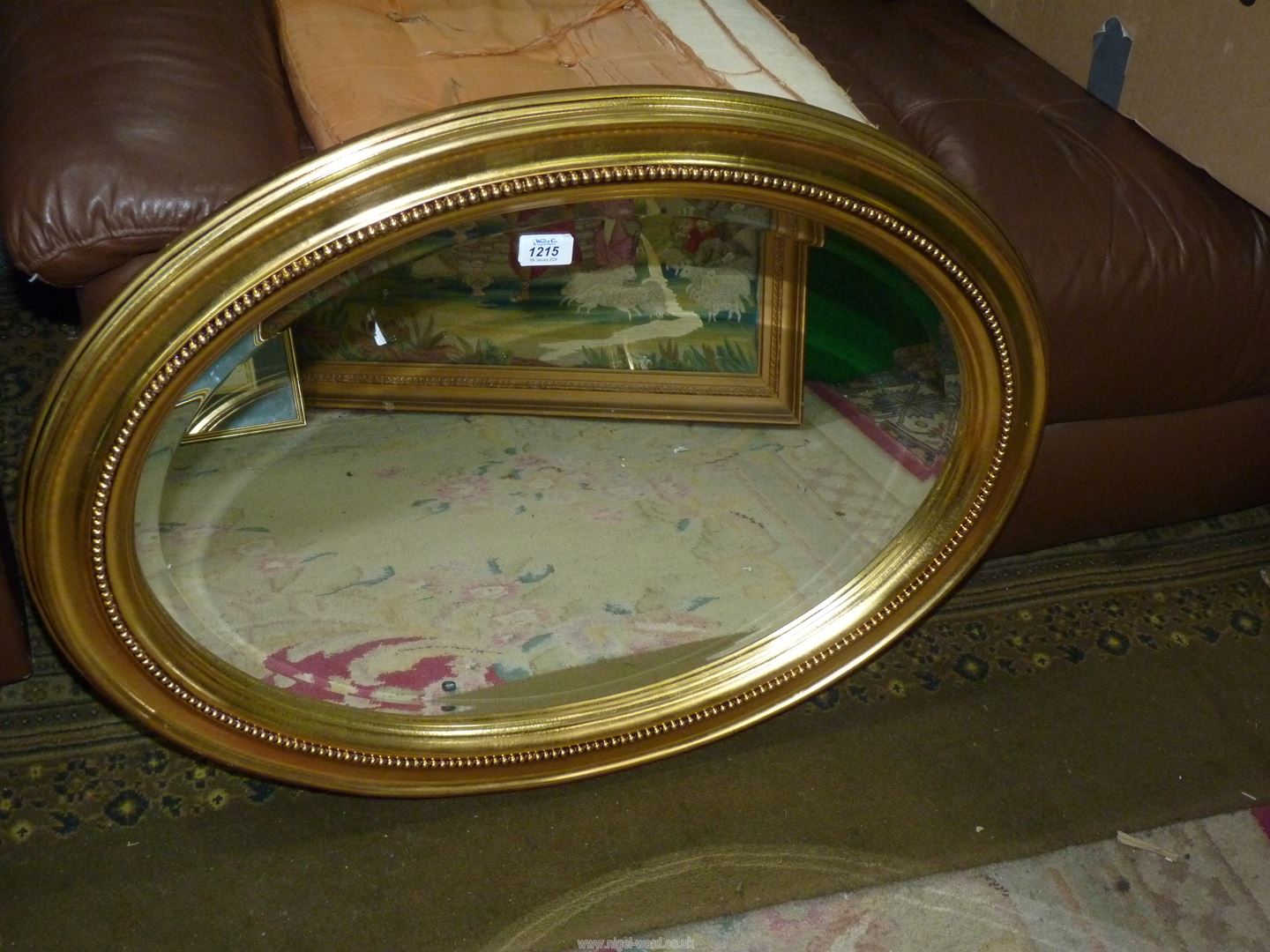 An oval gilt finished framed bevel plated Mirror, 25 1/2'' x 33''.