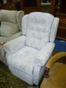A white/beige fleck upholstered electrically reclining/raising Armchair.
