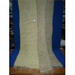 A Welsh wool waffle weave blanket in yellow with brown flecks.