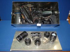 A metal box of photographic equipment, mostly lenses, some a/f.