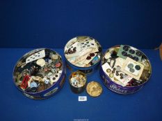 Four tins of miscellaneous buttons.