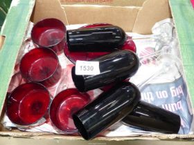 A small quantity of cranberry glass including dessert bowls and four champagne flutes.