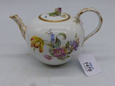 A Meissen teapot with floral decoration to the body and gold painted detail to the handle,