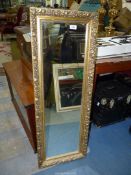 A rectangular gilt type finished framed mirror, 15 1/4" x 42".
