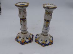 A pair of faience candlesticks.