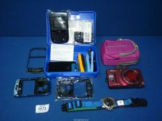 An Adidas watch, Blackberry 8900 phone components and Nikon Coolpix camera S9500.