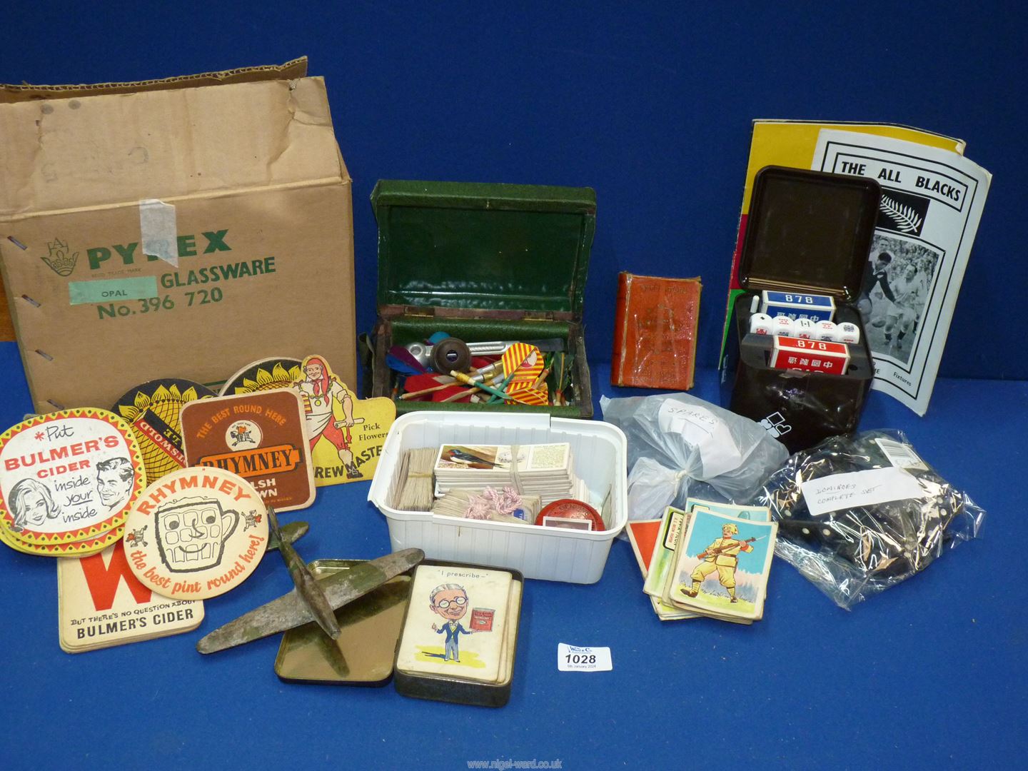 A quantity of miscellanea including metal model Spitfire, cigarette and tea cards, darts,