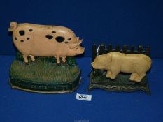 A cast metal Gloucester pig doorstop, 7" long and a Landrace pig doorstop, 6" long.