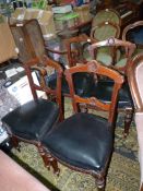 A set of four Mahogany framed circa 1900 Dining Chairs having turned front legs and a shell feature