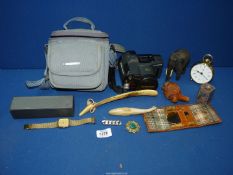 A box of music including a shoe horn, small Quartz battery clock, camera, Ronson lighter,
