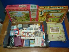 Two boxes of vintage advertising playing cards and puzzles.