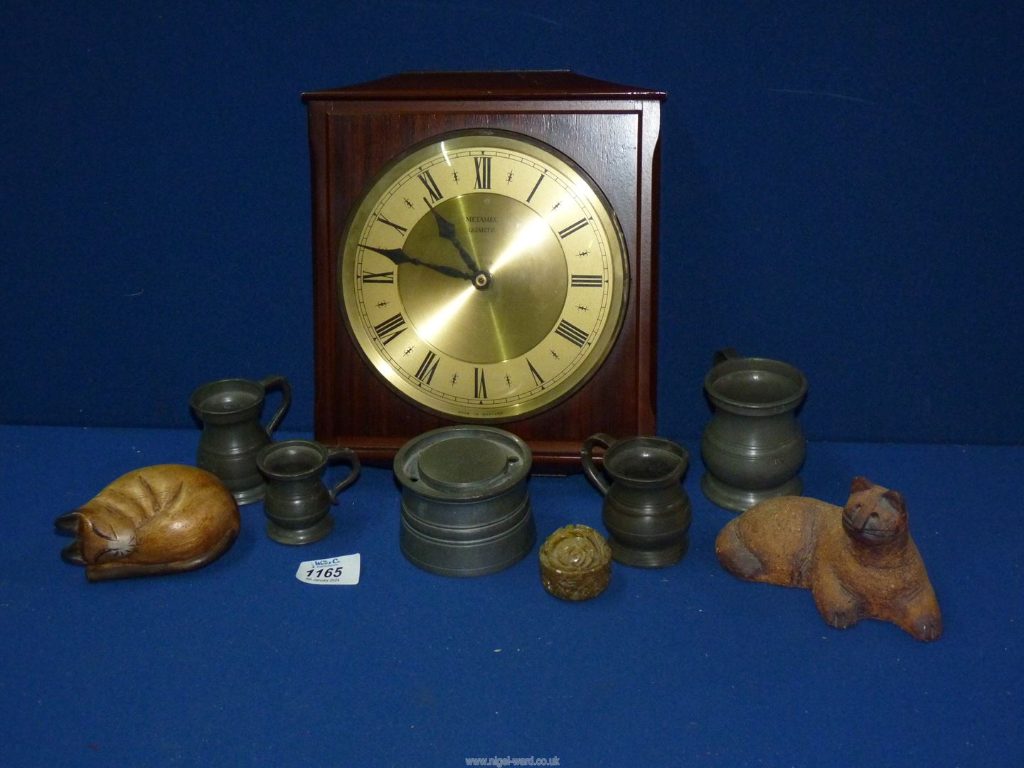 A Metamec quartz wall clock, pewter inkwell and four tankards, etc.