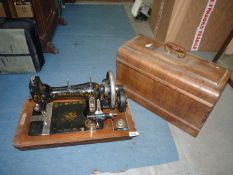 A National Victoria hand sewing machine with colourful detail, case a/f.