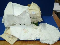 A quantity of vintage linen including crocheted doilies, tablecloths, etc.