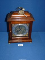A Comitti of London Mahogany style bracket Clock with silvered chapter ring, Roman numerals,