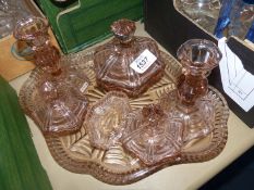 A pink glass dressing table set.