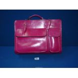 A bright pink Leather student style Handbag.