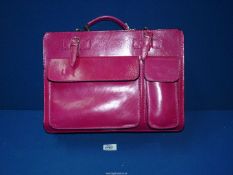 A bright pink Leather student style Handbag.