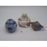 A Chinese smiling Buddha painted yellow and pink, 5 1/2" tall,