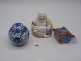 A Chinese smiling Buddha painted yellow and pink, 5 1/2" tall,
