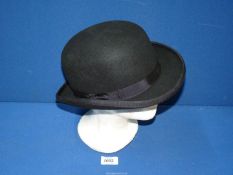 A bowler hat by D.H., size medium, 100% wool.