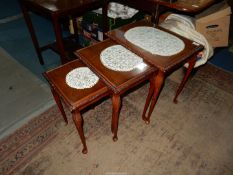 A nest of three Mahogany/Walnut occasional Tables standing on carved detail cabriole legs,
