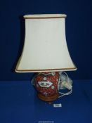An oriental Ginger Jar converted to an electric Lamp (crack to lid) standing on wooden base,