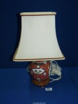 An oriental Ginger Jar converted to an electric Lamp (crack to lid) standing on wooden base,