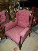 A darkwood framed wing Fireside Chair upholstered in lattice pattern maroon fabric (one rear leg