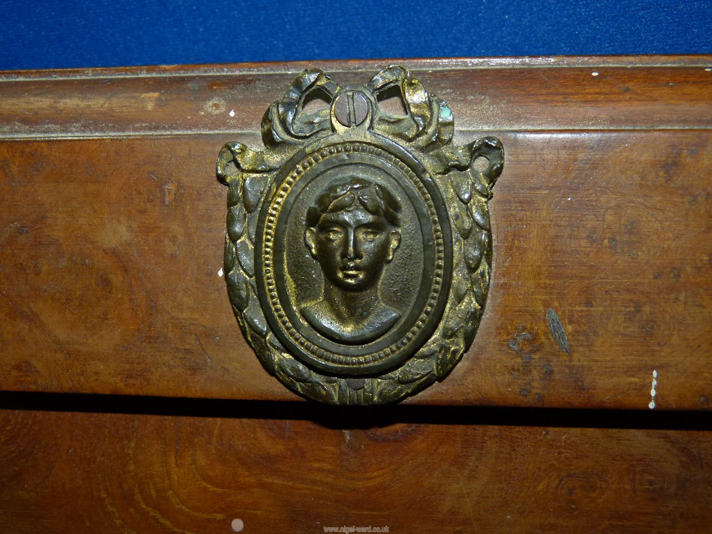 A Walnut type framed bevel plated mirror, with metal plaque to pediment depicting face of a lady, - Image 2 of 3