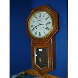 A Rosewood/Walnut finished Wm Oswin of Hereford octagonal surround eight-day Wall Clock having a