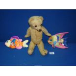 An old jointed Merrythought teddy bear from the 1950's and two "Beanie" baby fishes.