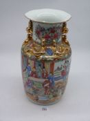 A large Chinese Cantonese vase having hand painted figures and warriors on horseback with gilt dogs