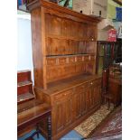 A medium Oak Dresser, the base with three double panel doors with three frieze drawers over,