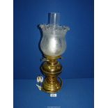 An oil lamp converted to electric with brass base and reservoir and etched glass shade, 19" tall.