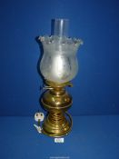 An oil lamp converted to electric with brass base and reservoir and etched glass shade, 19" tall.