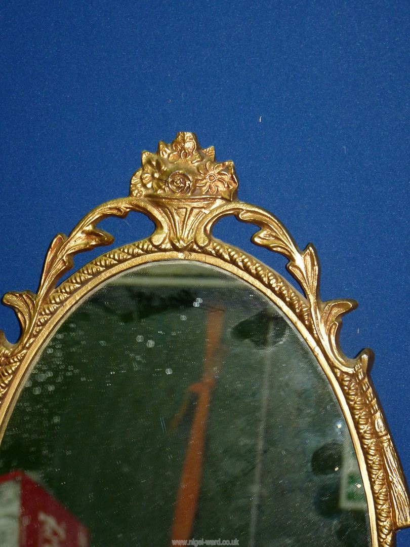 An ornately framed oval wall mirror, 19 3/4'' high x 10 1/2'' wide. - Image 2 of 2