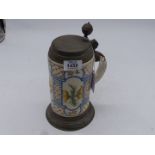 A German faience stein, 18th century, painted with flowers and with original pewter cover,