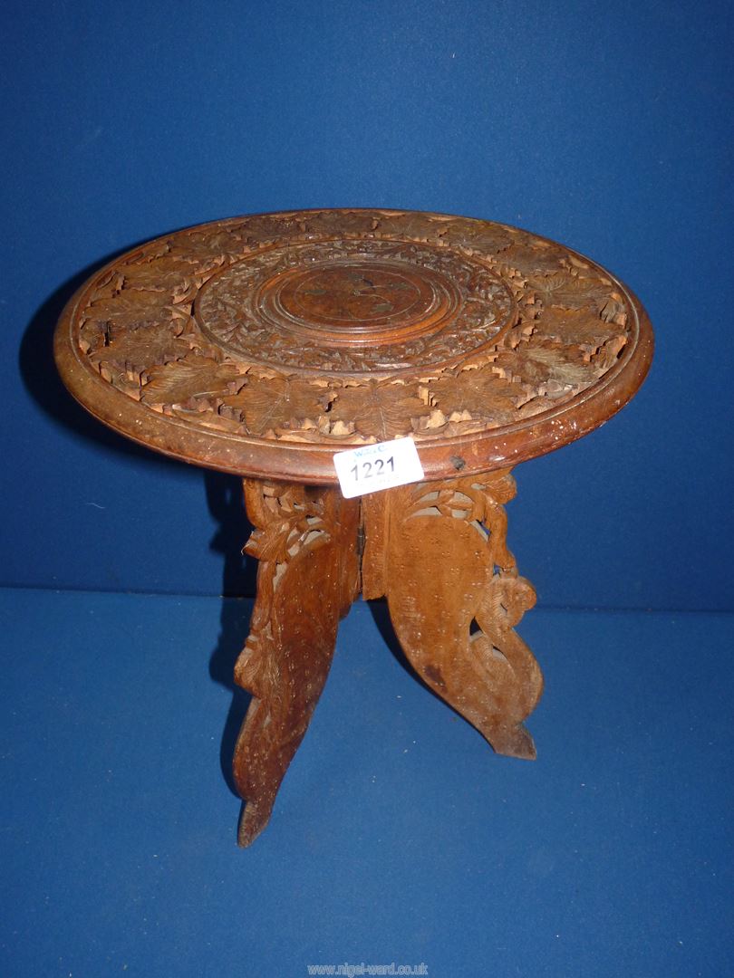 A foliate carved three legged Occasional table (fixed base), 15'' diameter x 15'' high.